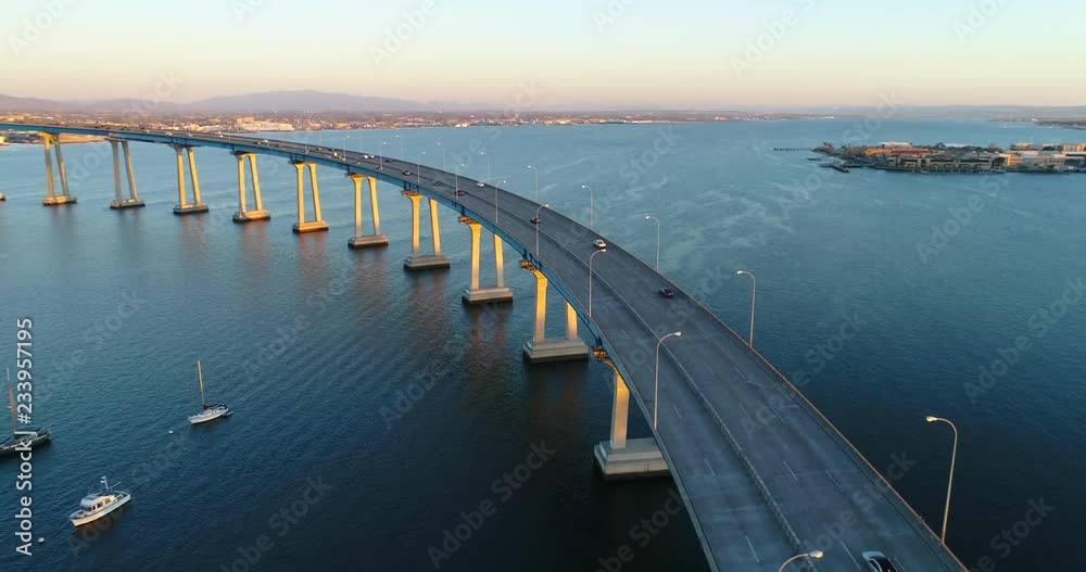 Aerial drone view cars traveling on the Coronado bridge at sunset, in San Diego, California.