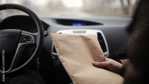 Selling secrets. A spy or a private detective sends a package of documents to the woman buyer in the car and gets in return the envelope with money, close-up.