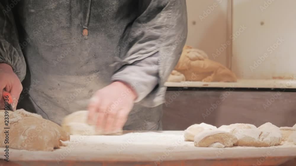 Man working with dough in commercial bakary Man working with dough in commercial bakary