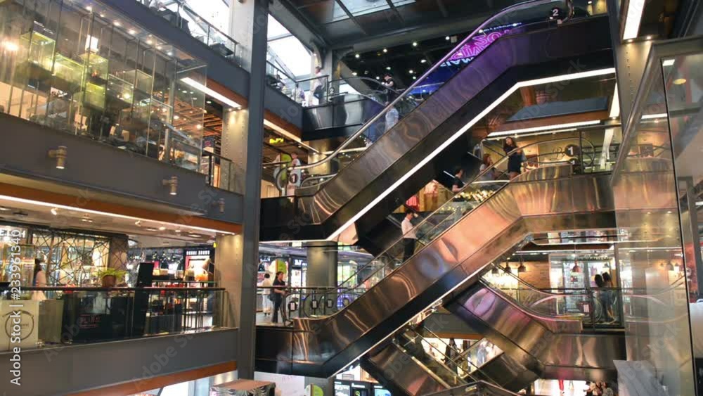 People and tourists using escalators at Siam Center shopping mall