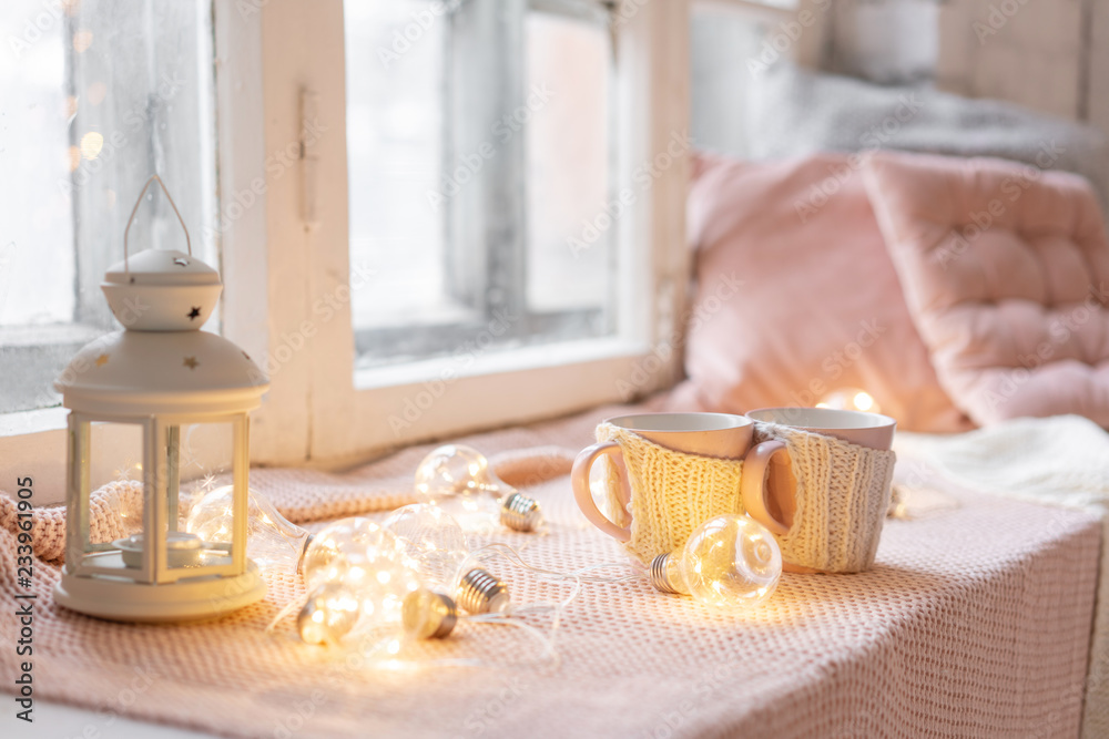 Knitted woolen cups on a wooden table. two cups of hot coffee. the concept of heat. holidays and events. Autumn and winter, leisure concept. Cozy, comfy, soft.