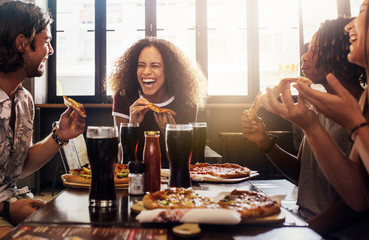 Friends enjoying while having food and drinks at cafe