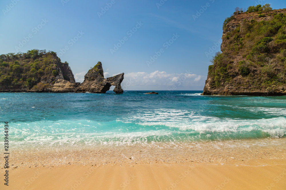 Magnificent view of unique natural rocks and cliffs formation in beautiful beach known as Atuh Beach located in the east side of Nusa Penida Island, Bali, Indonesia.