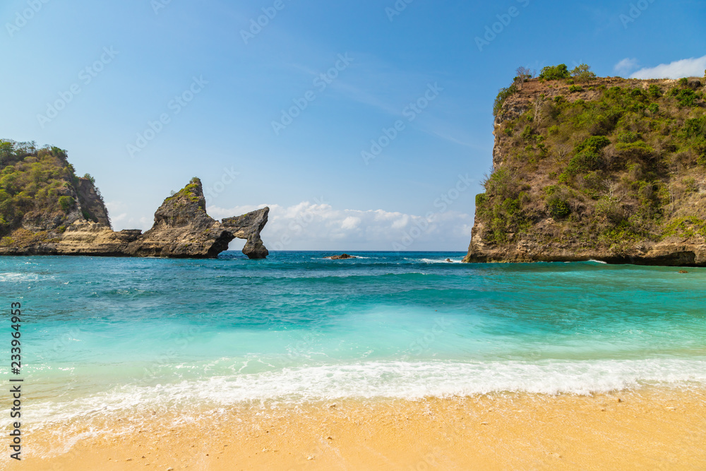 Magnificent view of unique natural rocks and cliffs formation in beautiful beach known as Atuh Beach located in the east side of Nusa Penida Island, Bali, Indonesia.