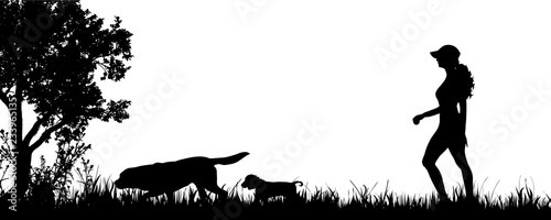 Vector silhouette of woman with dogs on the meadow.