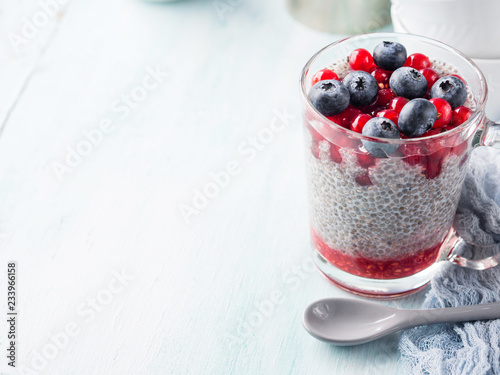 Almond milk chia pudding with fresh blueberries in a glass mug. Plant based breakfast