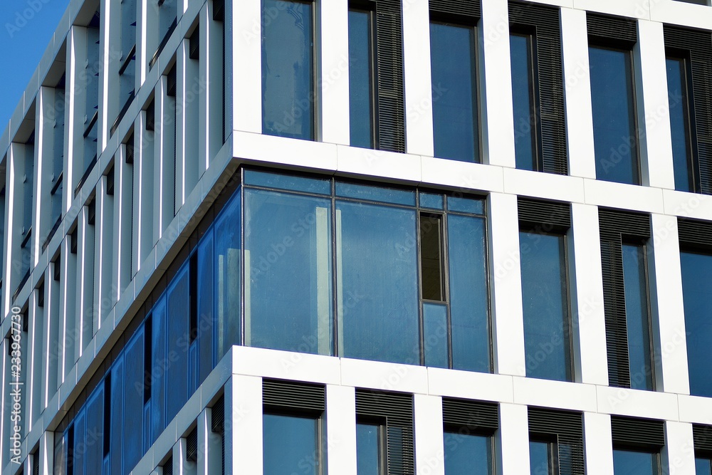 Fragment of a facade of a building with windows and balconies. Modern home with many flats. Fragment of a facade of a building with windows and balconies. Modern home with many flats.