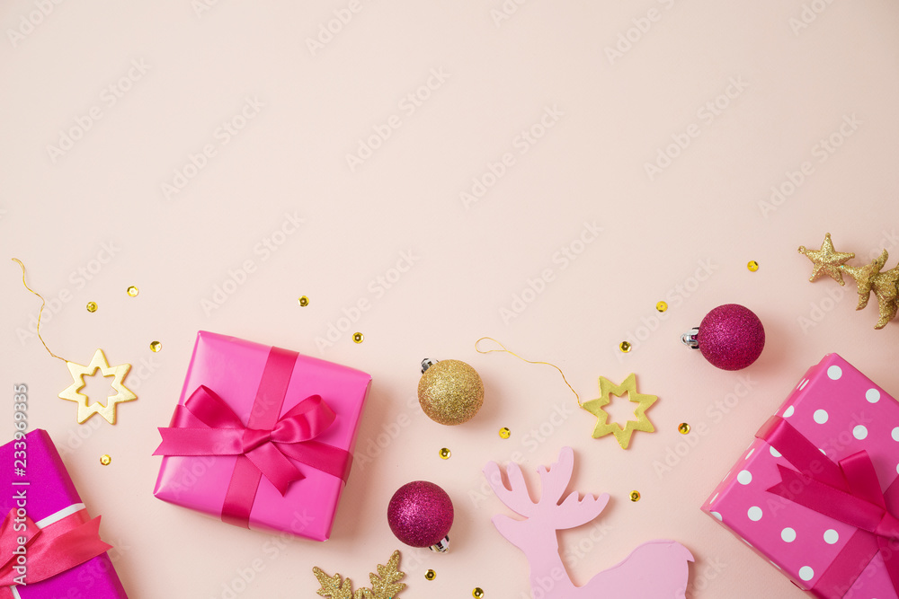 Christmas holiday background with pink gift boxes and decorations on table