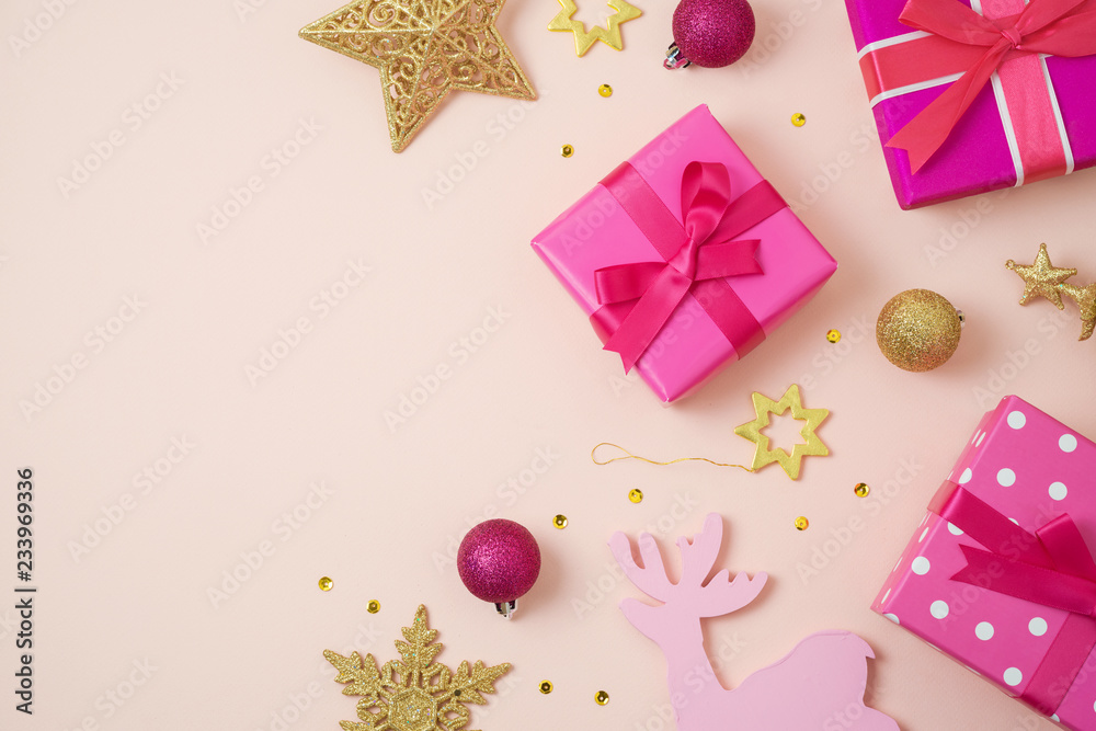 Christmas holiday background with pink gift boxes and decorations on table