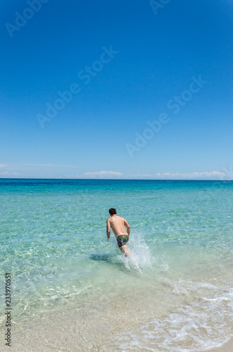 Man diving in a beach on the seacoast of Melendugno