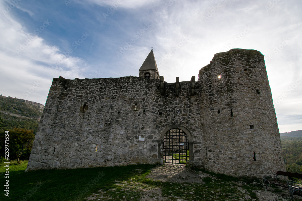Old Romanesque church of Holly Trinity within defensive fortress walls in Karst village of Hrastovlje in Istria, Slovenia Old Romanesque church of Holly Trinity within defensive fortress walls in Karst village of Hrastovlje in Istria, Slovenia