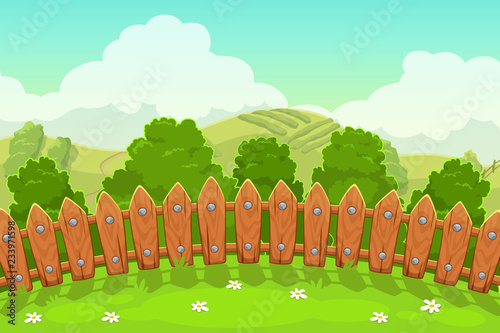 Beautiful countryside landscape with wooden fence, grass, trees, hills and cloudy sky.