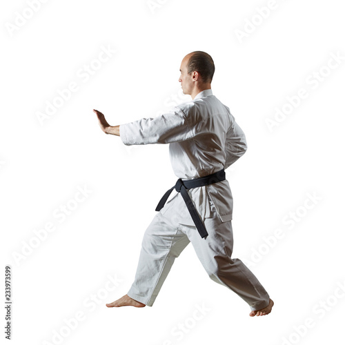 On a white isolated background, an active athlete performs formal exercises