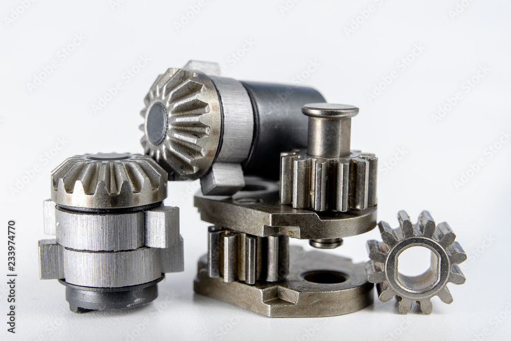 Wheels for mechanical gears on a white workshop table. Mechanical parts for mechanical devices. Wheels for mechanical gears on a white workshop table. Mechanical parts for mechanical devices.