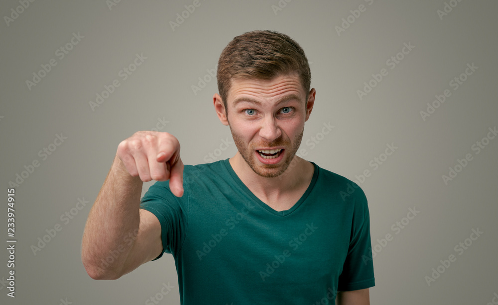 Portrait of a grumpy bearded man, angrily screaming, pointing his index finger directly at the camera. The guy accuses someone of doing the wrong thing, isolated on a white background Portrait of a grumpy bearded man, angrily screaming, pointing his index finger directly at the camera. The guy accuses someone of doing the wrong thing, isolated on a white background