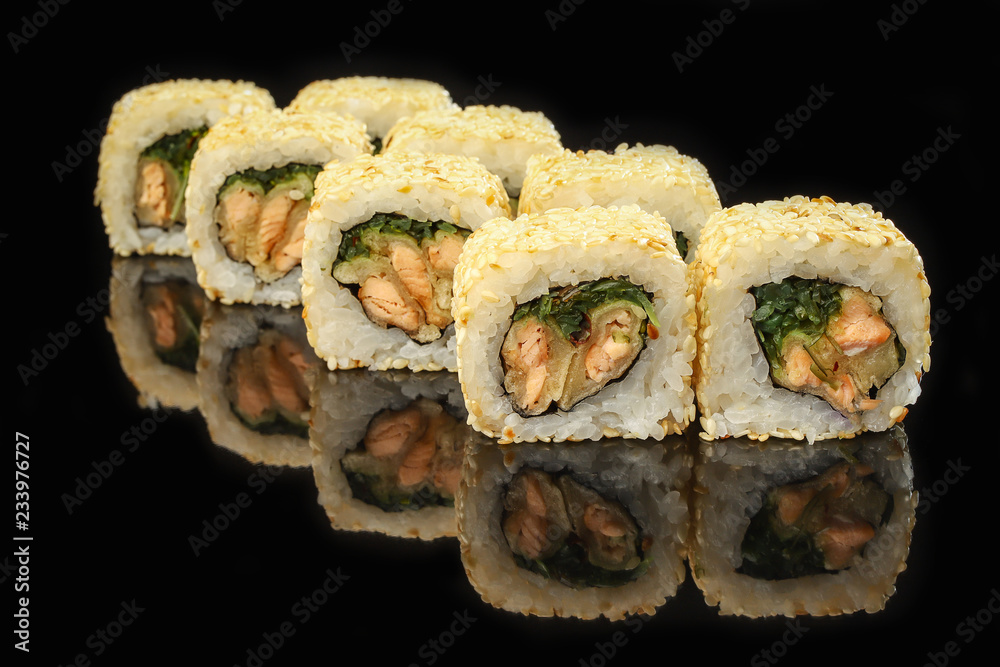 Traditional sushi roll with salmon on black stone. Japanese food Traditional sushi roll with salmon on black stone. Japanese food
