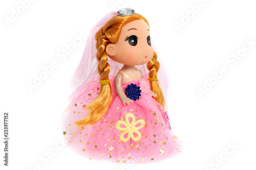 Fotografiet Cute doll is standing in a pink dress, as princess with flowers on white backgro