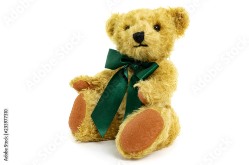 Cute teddy bear is sitting, toy is made from golden mohair complemented with pure wool