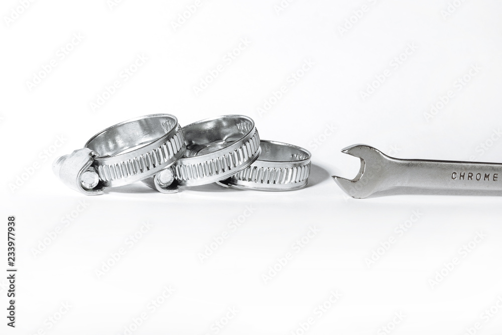 New metal hose clamps with threaded connection for pipes, stainless steel, small size on isolated white background close-up New metal hose clamps with threaded connection for pipes, stainless steel, small size on isolated white background close-up