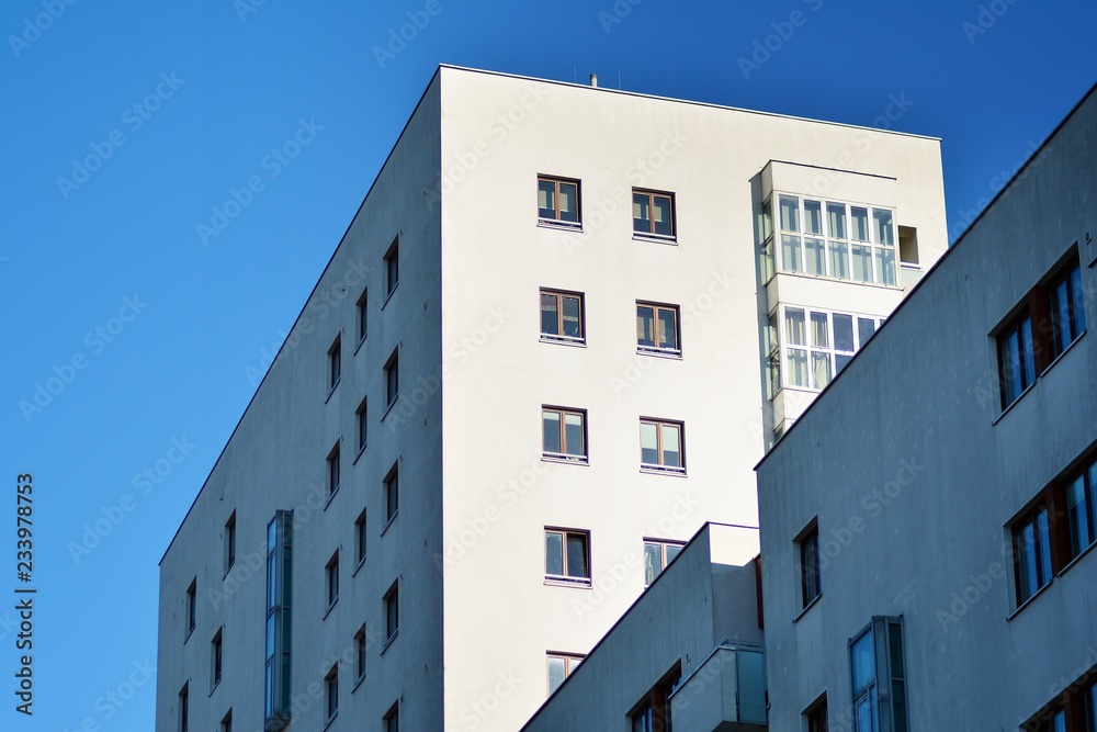 Fragment of a facade of a building with windows and balconies. Modern home with many flats. Fragment of a facade of a building with windows and balconies. Modern home with many flats.