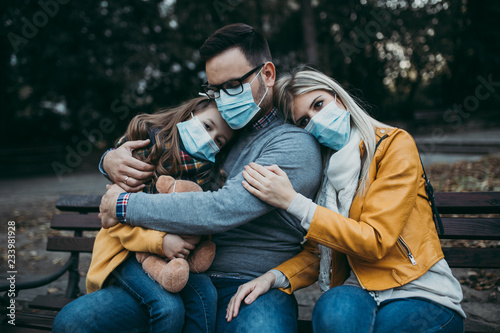 Young family in protective mask outdoors in park. Air pollution concept. © hedgehog94