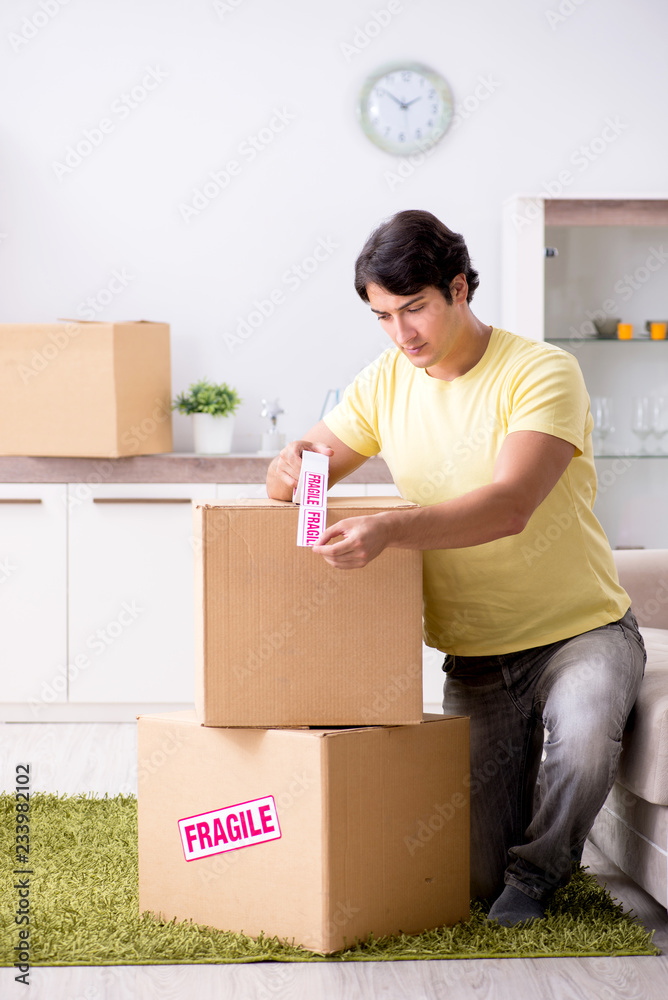 Man moving house and relocating with fragile items