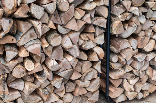 stacked firewood in black metal rack