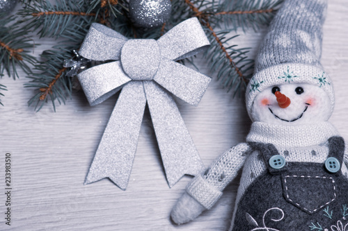 Christmas snowman close-up on the background of the Christmas tree.