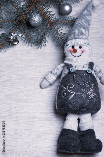 Christmas snowman close-up on the background of the Christmas tree.