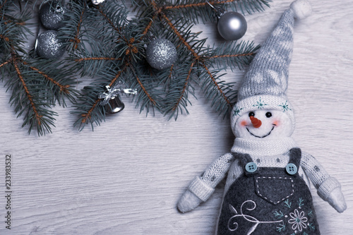 Christmas snowman close-up on the background of the Christmas tree.
