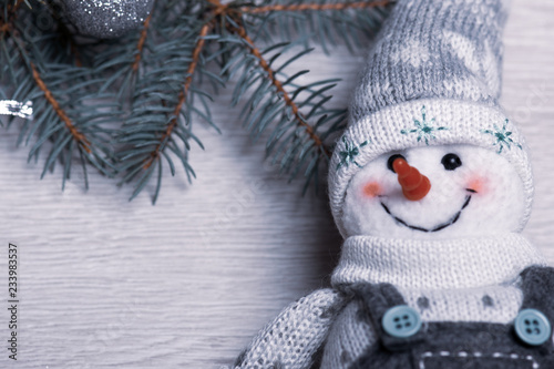 Christmas snowman close-up on the background of the Christmas tree.