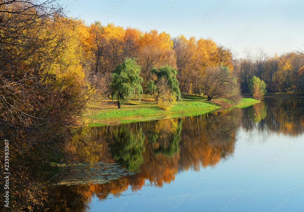 Landscape park with a pond golden autumn during leaf fall. Landscape park with a pond golden autumn during leaf fall.