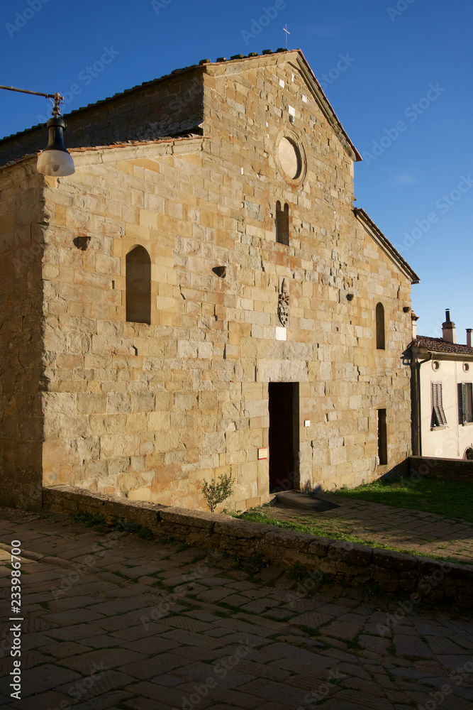 Facade of the old Romanesque church Pieve di San Pietro a Gropina. Loro Ciuffena, Tuscany, Italy.