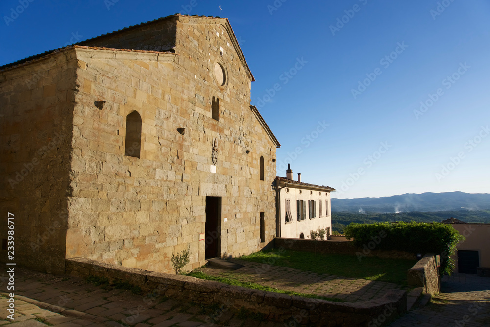 Facade of the old Romanesque church Pieve di San Pietro a Gropina. Loro Ciuffena, Tuscany, Italy.