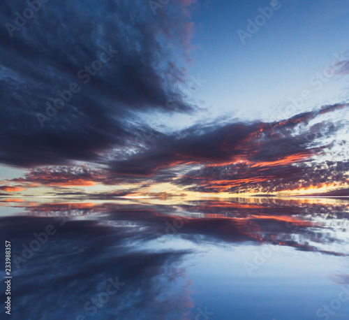 Reflection of colorful sunset clouds - Stock image