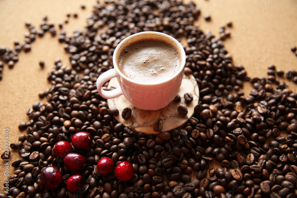 Fototapeta premium cup of coffee with beans on wooden background
