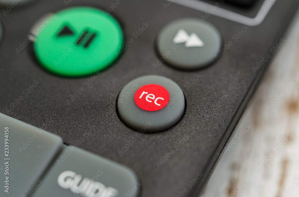 Close up macro photography of a smart tv television remote control with recording button. Concept of show, business, recording, tv, action, and radio Close up macro photography of a smart tv television remote control with recording button. Concept of show, business, recording, tv, action, and radio