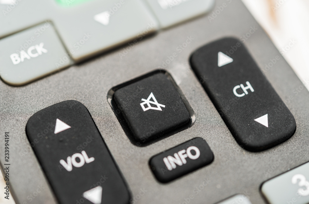 Close up macro photography of a smart tv television remote control with volume button. Concept of silence, fake news, and propaganda Close up macro photography of a smart tv television remote control with volume button. Concept of silence, fake news, and propaganda