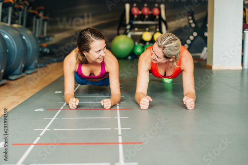 Young fit women working together in gym club
