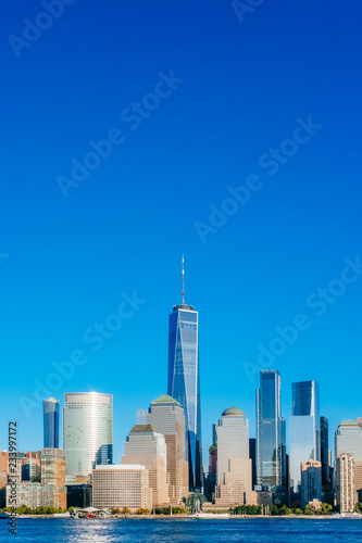 Skyline of downtown Manhattan over Hudson River under blue sky, at sunset, in New York City, USA