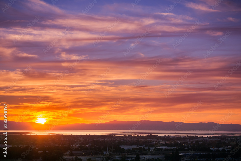 Sunset view of Hayward and Union City from Garin Dry Creek Pioneer Regional Park, east San Francisco bay shoreline and San Mateo bridge in the background, California