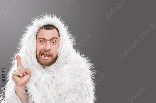 Caveman in animal skin on isolated background shows thumb up