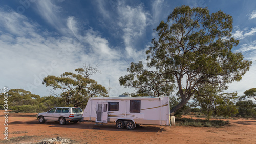 Four wheel drive vehicle and large caravan parked in a rest stop in the outback of Australia. © Philip Schubert