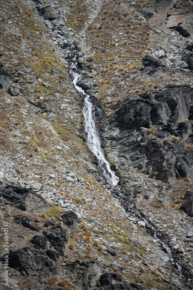 A waterfall at the top of the Remarkables near Queenstown in New Zealand A waterfall at the top of the Remarkables near Queenstown in New Zealand