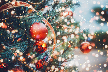 Christmas tree with red ball ornament and decoration, sparkle light. Christmas and New Year holiday background. vintage color tone.