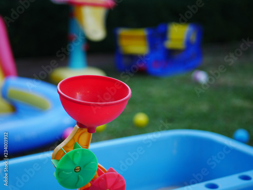Kids water of sand toy closeup with toys in background
