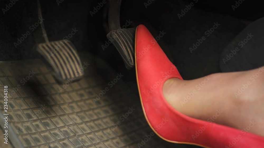         4K.Woman In Red High Heels Shoes Pressing Car Pedals