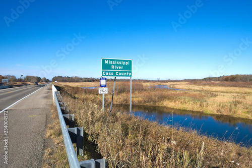 Mississippi River flowing flowing under US Highway 2 in northern Minnesota on sunny morning. This bridge is located between Grand Rapids and Bemidji. photo