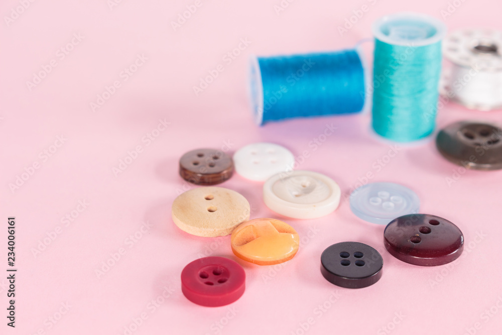 sewing button on pink background. sewing button on pink background.