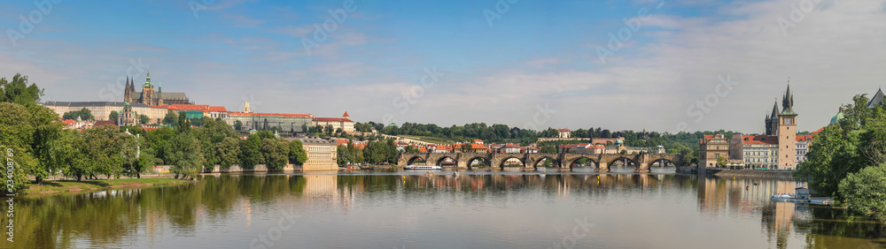 View of the Vltava Embankment, Charles Bridge and St. Vitus Cathedral in Prague, Czech Republic
